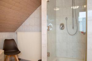 a bathroom with a shower with a glass door at Wohnung Karin in Spalt +18 photos