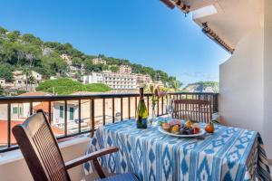 a table with a bowl of fruit on a balcony at Delta 3 in Sóller