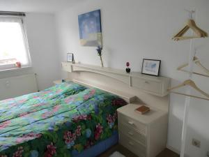 a bedroom with a bed with a floral bedspread at Ferienwohnung Max und Moritz in Mirow