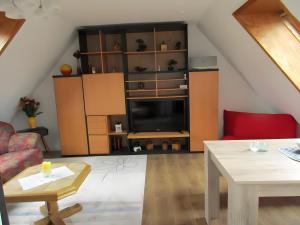 a living room with a couch and a table at Ferienwohnung Max und Moritz in Mirow