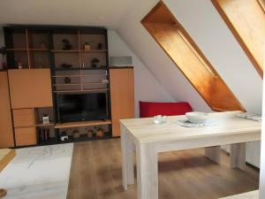 a dining room with a table and a tv at Ferienwohnung Max und Moritz in Mirow