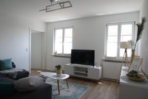 a living room with a couch and a flat screen tv at Ferienwohnung am Stadtwall in Stockach