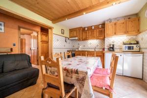 a kitchen with a table and a couch in a room at Apt Chénives 2 - Morzine in Morzine