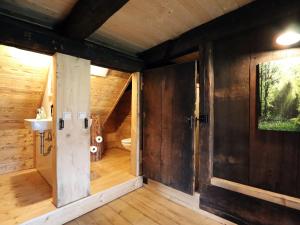 an open door to a bathroom in a log cabin at Ferienhütte Biobetrieb Lippenhof in Bruckbach