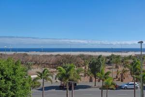 a parking lot with palm trees and the ocean at Casa Santana in Vecindario