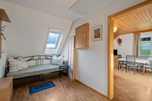 a room with a bed and a dining room at Dorerhof Prechtal in Elzach