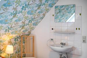 a bathroom with a sink and a mirror at Dorerhof Prechtal in Elzach +35 photos