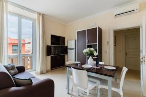 a kitchen and dining room with a table and chairs at Palazzo Mongiò in Gallipoli