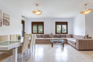 a living room with a couch and a table at Casa Guadalmar in Málaga