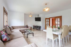 a living room with a couch and a table at Casa Guadalmar in Málaga
