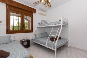 a room with two bunk beds and a bed at Casa Guadalmar in Málaga +22 photos