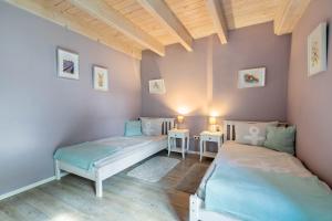 a room with two beds and two tables at Ferienwohnung Hof Krakebüll in Humptrup