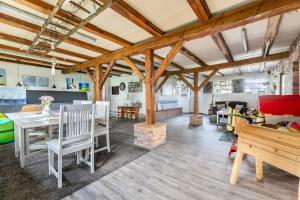 a living room with wooden ceilings and a table and chairs at Ferienwohnung Hof Krakebüll in Humptrup