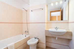 a bathroom with a sink toilet and a mirror at Talaia 1a in Port de Pollensa +18 photos