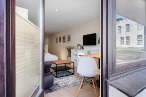 a small apartment with a desk and a table at Wohnung Früger in Westerland