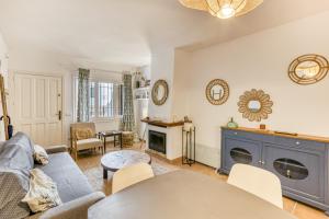 a living room with a couch and a fireplace at Calella Pallafrugell in Palafrugell
