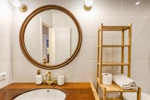 a bathroom with a sink and a mirror at Calella Pallafrugell in Palafrugell +21 photos
