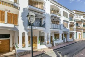 a street light in front of a white building at Calella Pallafrugell in Palafrugell