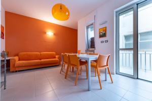 a living room with a table and chairs and a couch at Dimora lungomare terra d'otranto in Otranto