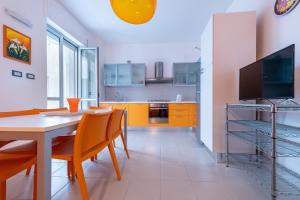 a kitchen with a table and chairs and a tv at Dimora lungomare terra d'otranto in Otranto