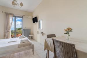 a dining room with a table and chairs and a window at Nontas Home 22 in Kalamitsi