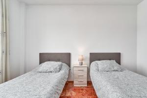 two beds sitting next to each other in a bedroom at Casa Axarquia in Vélez-Málaga