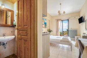 a bathroom with a bath tub and a sink at Nontas Home 22 in Kalamitsi +23 photos