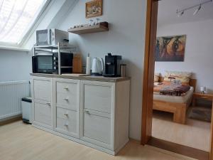 a room with a counter with a microwave and a bed at Apartment Schwär in Endingen