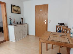 a living room with a wooden table and a dining room at Apartment Schwär in Endingen