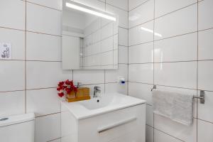 a white bathroom with a sink and a mirror at El Ramonal Home in Candelaria +18 photos