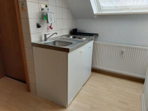 a small kitchen with a sink and a refrigerator at Apartment Schwär in Endingen +15 photos