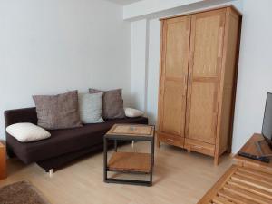 a living room with a black couch and a table at Apartment Schwär in Endingen
