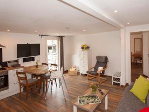a living room with a table and a dining room at Ferienhof Bieke in Finnentrop