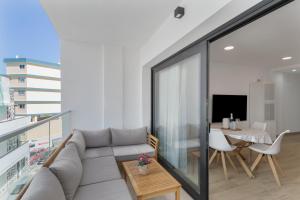 a living room with a couch and a table at Lupama Suite in Arguineguín