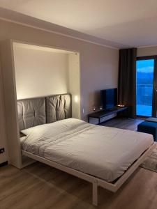 a bedroom with a large bed and a large window at Wellness Appartement Winterberg E2 in Winterberg