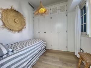 a bedroom with a bed and a basket on the wall at Villa Delicias in Melenara