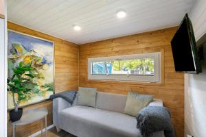 a small living room with a couch and a television at Tiny House Nr 5 in Schwielowsee