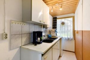 a small kitchen with a sink and a counter at Bungalow 10 - Finnhütte in Niesky