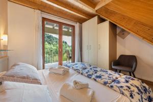 a bedroom with a large bed with a window at Residence Tatiana B2 in Tremosine Sul Garda +27 photos