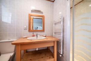 a bathroom with a sink and a mirror and a tub at Chalet 3 Etoiles - Le pèlouêt in Morzine +20 photos