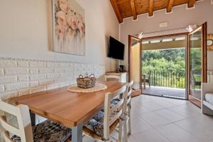 a dining room with a wooden table and chairs at Residence Tatiana B2 in Tremosine Sul Garda