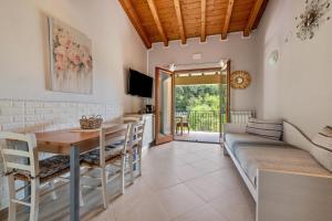 a living room with a table and a couch at Residence Tatiana B2 in Tremosine Sul Garda