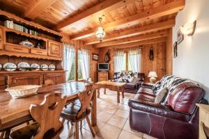 a living room with a table and a couch at Chalet 3 Etoiles - Le pèlouêt in Morzine