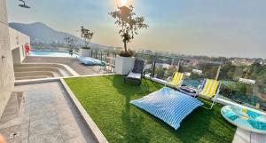 a balcony with a view of a pool and grass at 2BR Fantasea condo kamala in Kamala Beach