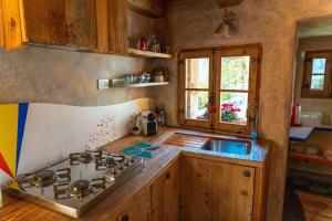 a kitchen with a stove top and a sink at Chalet Atmosfera Res Albert in San Guglielmo