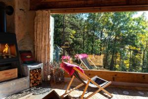 a chair sitting in a room with a window at Chalet Atmosfera Res Albert in San Guglielmo +5 photos