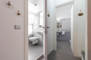 a bathroom with a toilet and a sink at Dormiamoci Sù in Mottola +21 photos