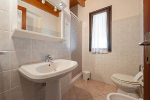 a bathroom with a sink and a toilet at Casa Silvia in Calasetta +16 photos