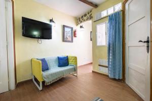 a living room with a couch and a tv on the wall at Casa Amparo in Icod de los Vinos