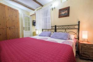 a bedroom with a large bed with a red blanket at Casa Amparo in Icod de los Vinos